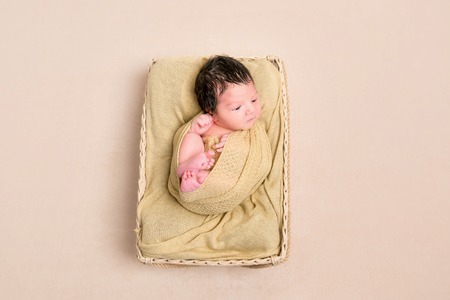 Wrapped black-haired baby basket, topviewの写真素材