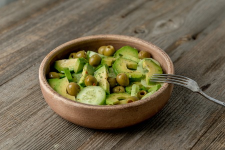 portion of vegeterian salad with olives, avocadoの写真素材