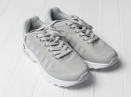 Gray cozy running shoes sitting on woodの写真素材