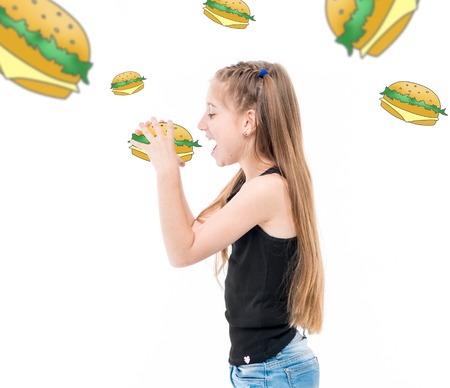 teen girl eating hamburgers, hamburgers around herの写真素材