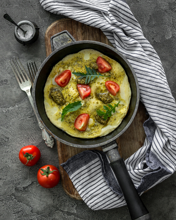 Homemade omelette with pesto sauce and mozzarella cheeseの写真素材