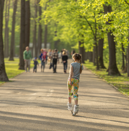 Teen girl skating in park in springの写真素材