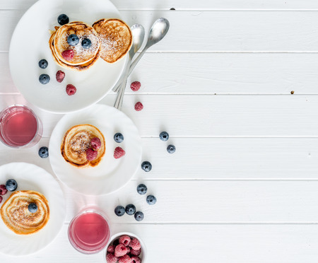 homemade fritters with raspberries and blueberriesの写真素材