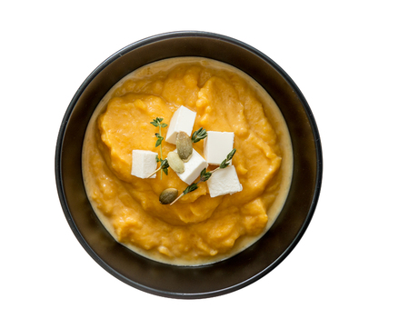 pumpkin soup in black plates on a white background isolatedの写真素材