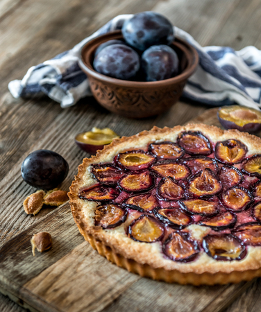 Homemade plum pie on the wooden backgroundの写真素材