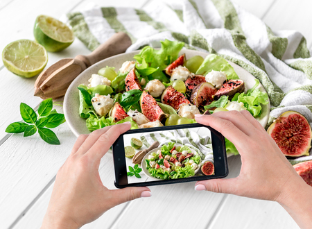 Womens hands photograph vegetarian saladの写真素材