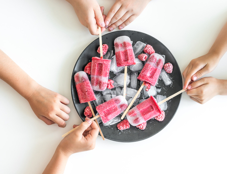Childrens hands take the ice creamの写真素材