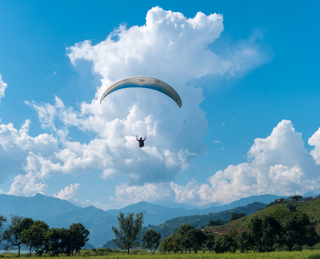 landing with parachute after paragliding in Nepalの写真素材