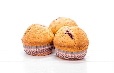 homemade muffins on a white wooden background