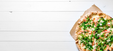 Italian pizza on white wooden backgroundの写真素材