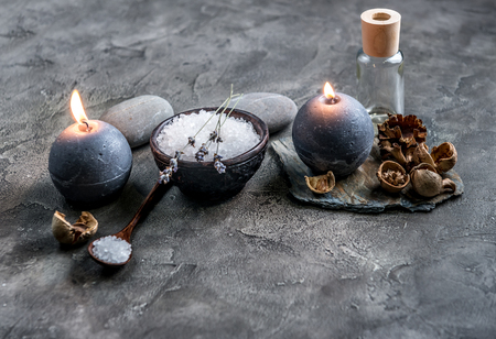 Bowl of spa salt and candles on grey backgroundの写真素材