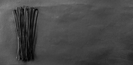 Squid ink fettuccine pasta on grey backgroundの写真素材