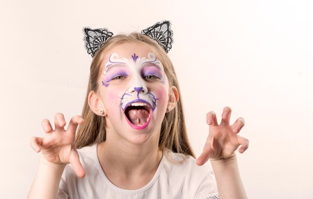Portrait of teen girl with cat face paintingの写真素材