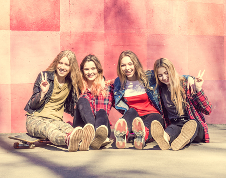 Four cool teenage girls with skatesの写真素材