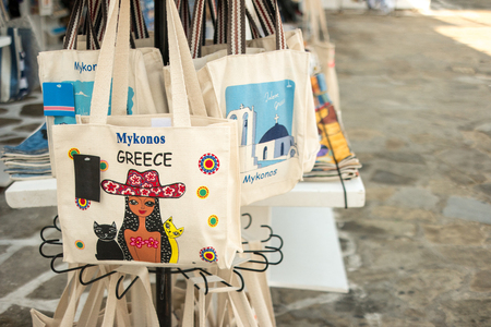 Silhouettes of people walking by the embankment in Greeceの写真素材