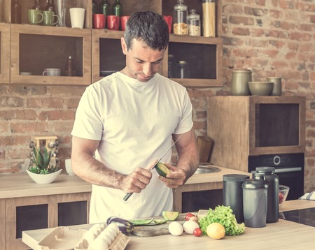 man peel the avocado kitchenの写真素材