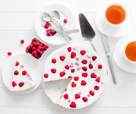 Panna cotta raspberries on a wooden white serving table. top viewの写真素材