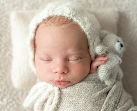 Closeup of little sleeping with toy