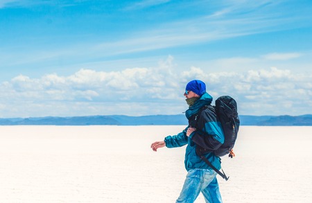Tourist walking in sunshine Salar de Uyuniの写真素材