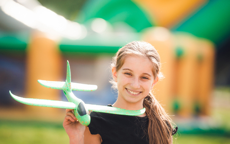 Girl playing with airplaneの写真素材