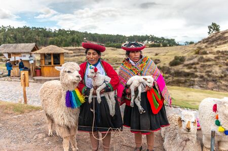 Peru - October 11, 2018: Peruvian women in dress with lamasのeditorial素材