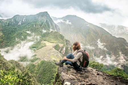 Girl-hiker looking on top of Huayna Picchu, looking on Machu Picchuの写真素材