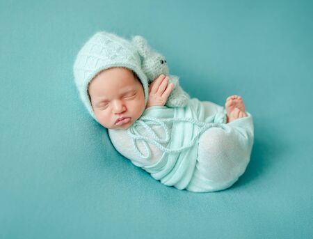 Newborn child sleeping in blanketの写真素材