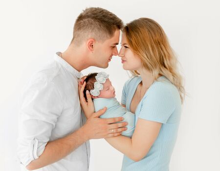 young beautiful parents holding a newborn daughterの写真素材