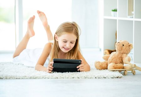 Little girl playing on her tabletの写真素材