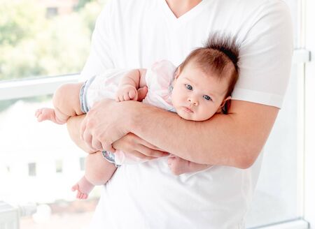 Baby protected by fathers hands