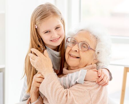 Little girl embracing grandmother