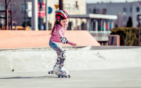 little cute girl riding on roller skates