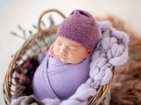Cute newborn in purple hatの写真素材