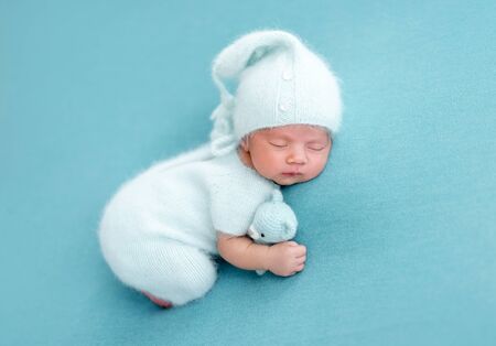 Cute newborn in knitted suitの写真素材