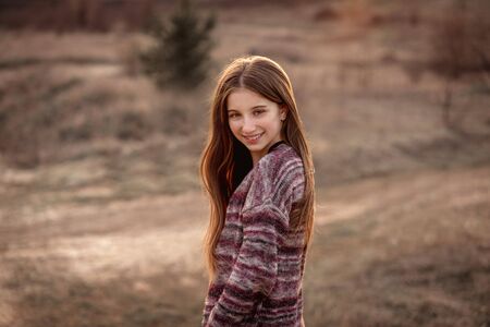 Girl with sun in fluttering hair