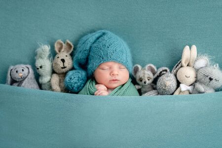 Beautiful newborn with knitted toys