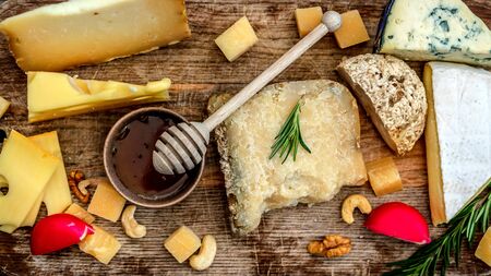Top view of cheese assortment on wooden boardの写真素材