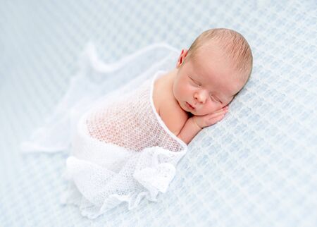 Cute naked newborn sleeping on stomachの写真素材