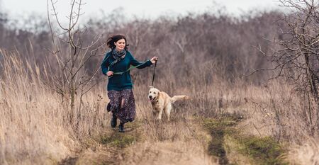 Happy woman with lovely dogの写真素材