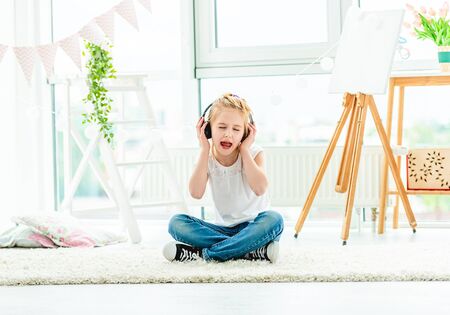 Cute little girl in headphones singingの写真素材