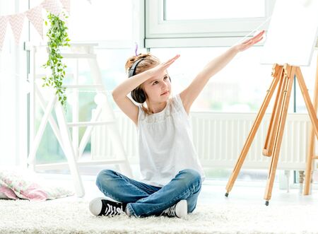 Happy little girl holding hands upの写真素材