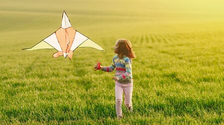 Little girl with flying kiteの写真素材