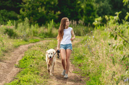 Girl running with dog on nature
