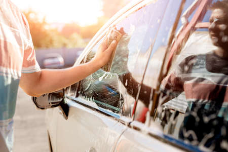 Hand with sponge is cleaning carの写真素材
