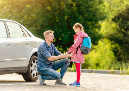 Father meeting little girl after classesの写真素材