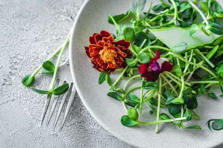 Fork and knife on plate with saladの写真素材