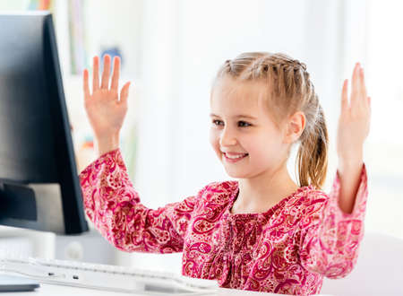 Little girl talking via computer