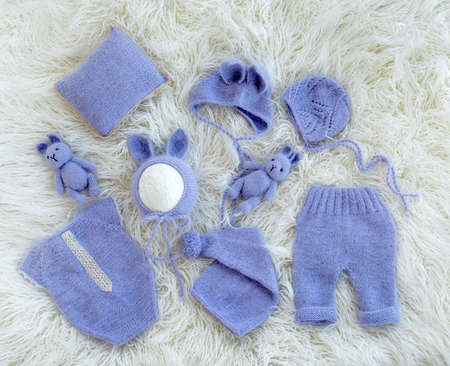 Composition of white-pink knitted suit and hat