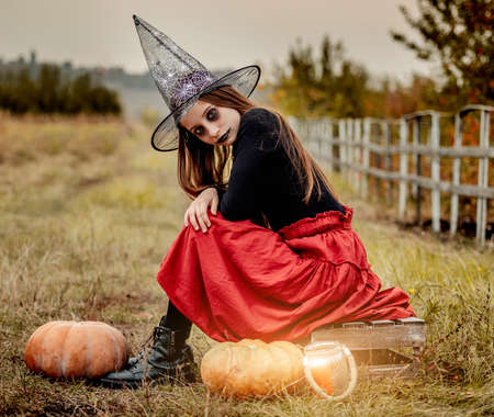 Young girl in halloween makeup and costume