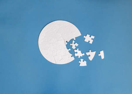 white round shaped jigsaw puzzle on blue